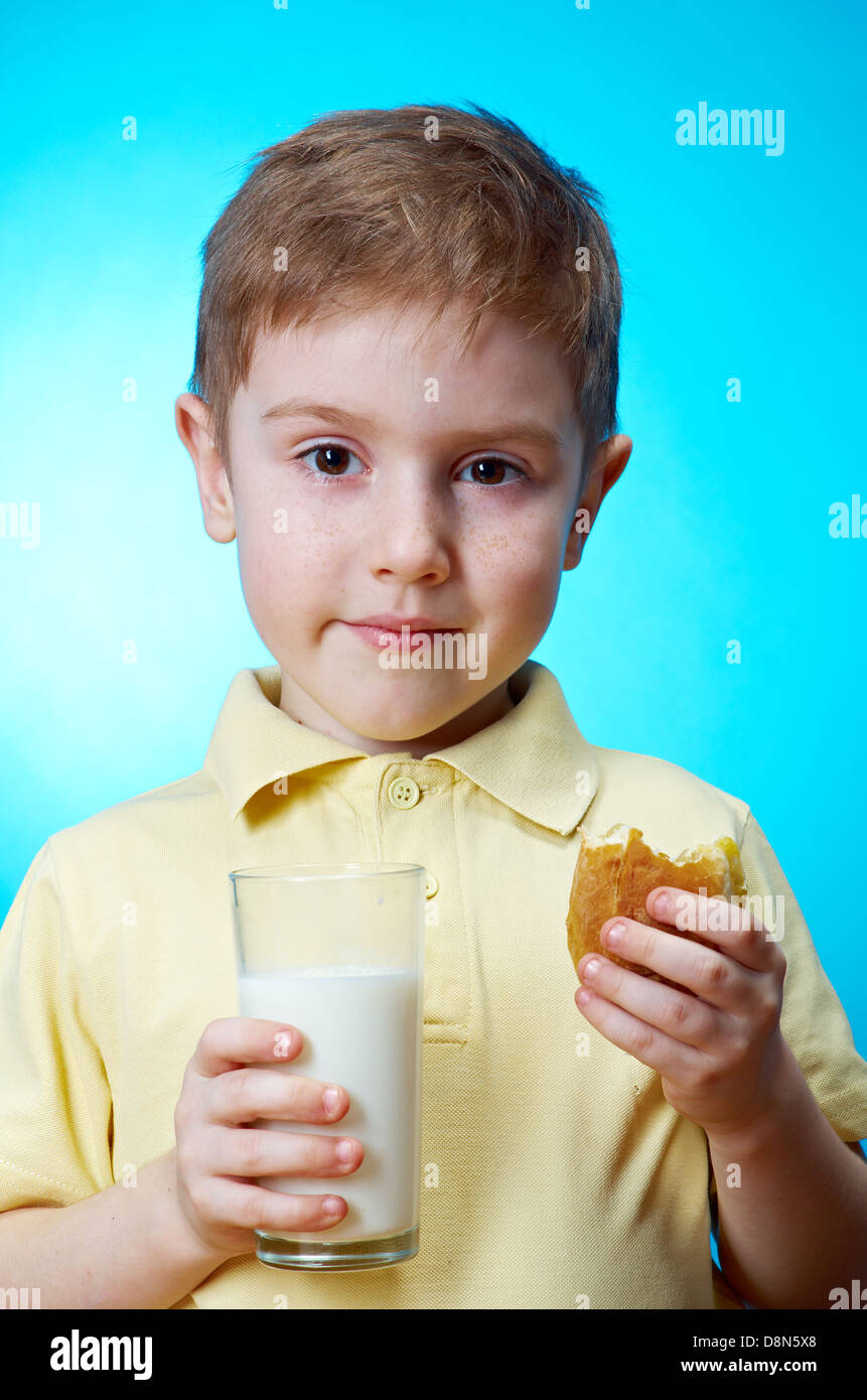 little boy eats homemade pie and glass of milk Stock Photo Alamy