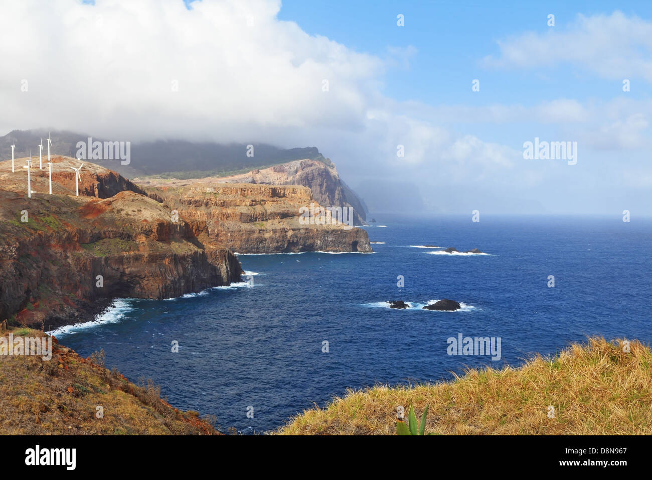 Windmills on abrupt coast of Atlantic ocean Stock Photo