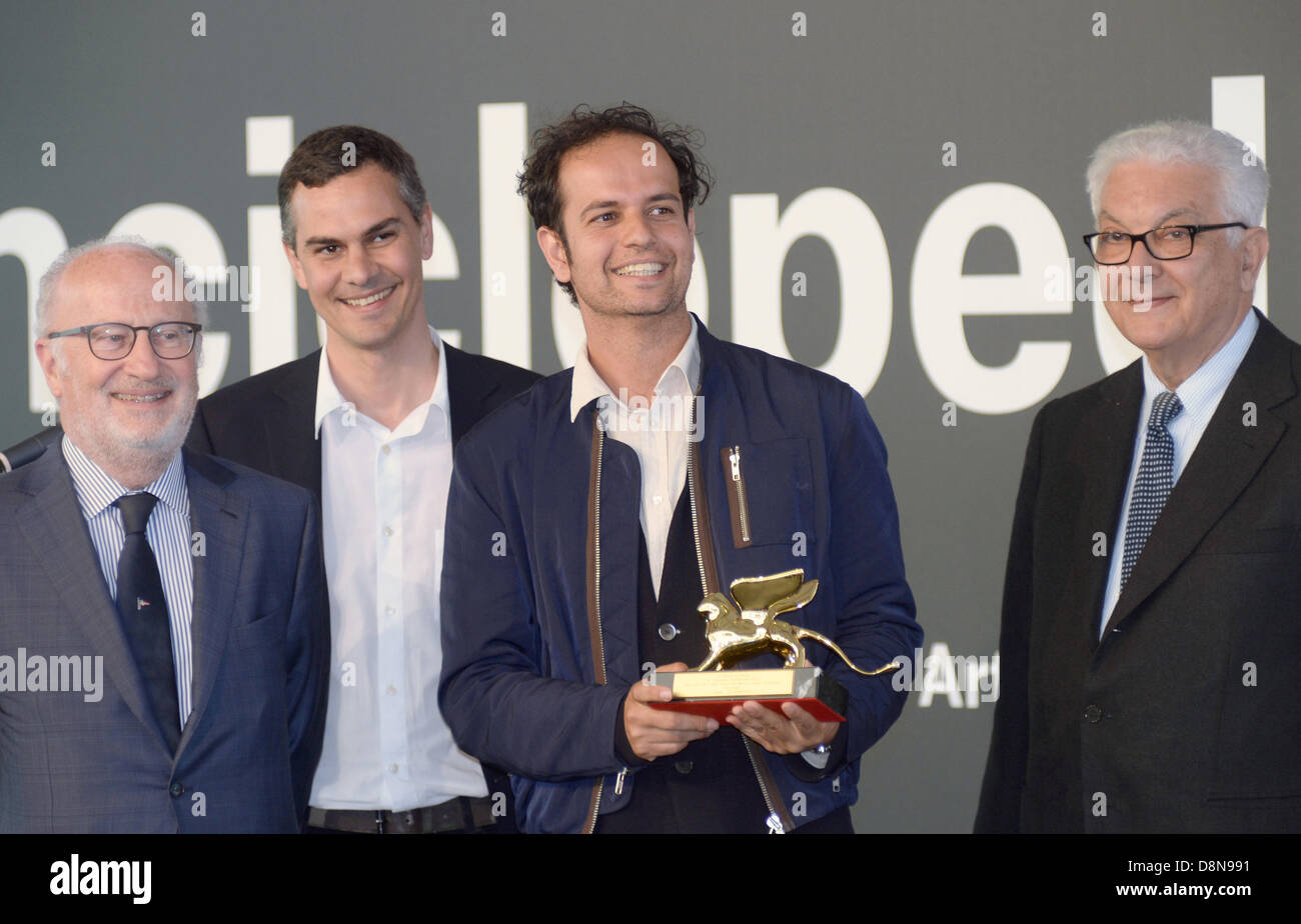 Venice, Italy. 31st May 2013. German artist Tino Sehgal poses for a photo with Golden Lion award for the best artist in Venice, Italy, 31 May 2013. Next to him stand Massimiliano Gioni (2-L), curator of the 55th Biennale and Paolo Baratta, president of the Bienalle. The 55th international contemporary art exhibition, La Biennale di Venezia 2013, will be opened on 01 June. Photo: Felix Hoerhager/dpa/Alamy Live News Stock Photo