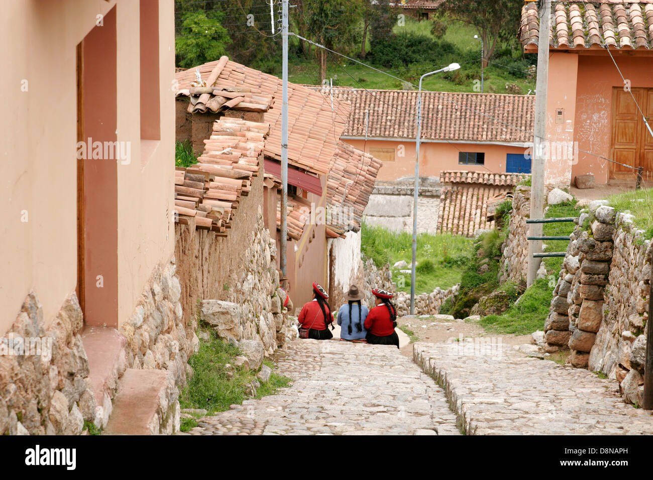 Three indigenous women sitting on the street of Chinchero, typical Andean village near Cuzco, Peru, South America Stock Photo