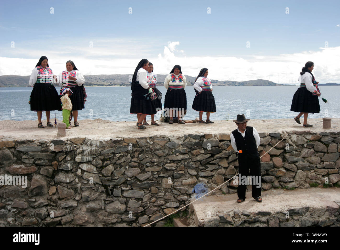 Local people meeting tourists on the pier of Amantani Island, Lake Titicaca, Peru, South America Stock Photo