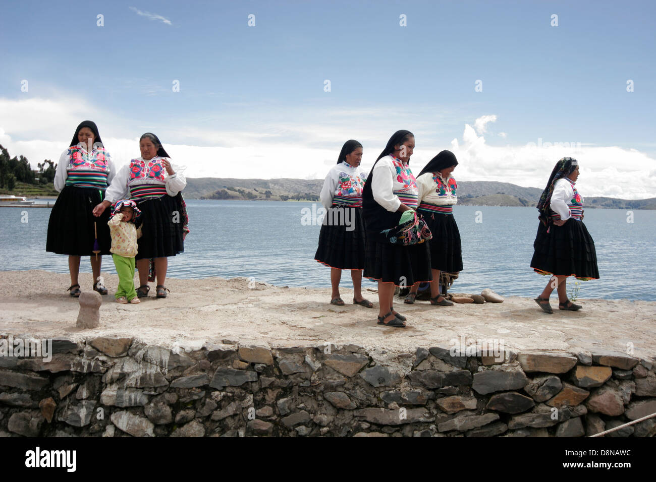 Local people meeting tourists on the pier of Amantani Island, Lake Titicaca, Peru, South America Stock Photo