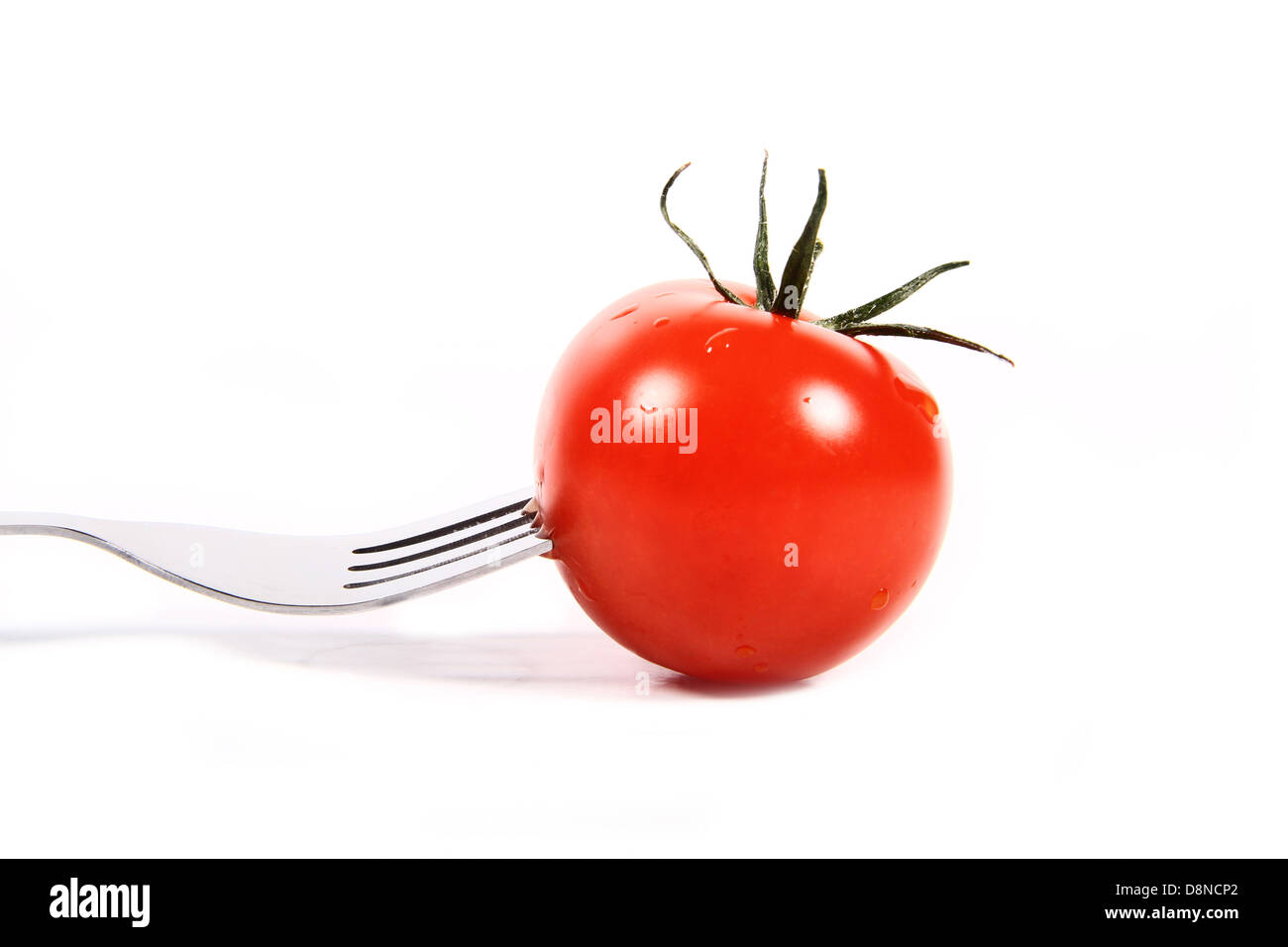 fresh red tomato on a fork Stock Photo