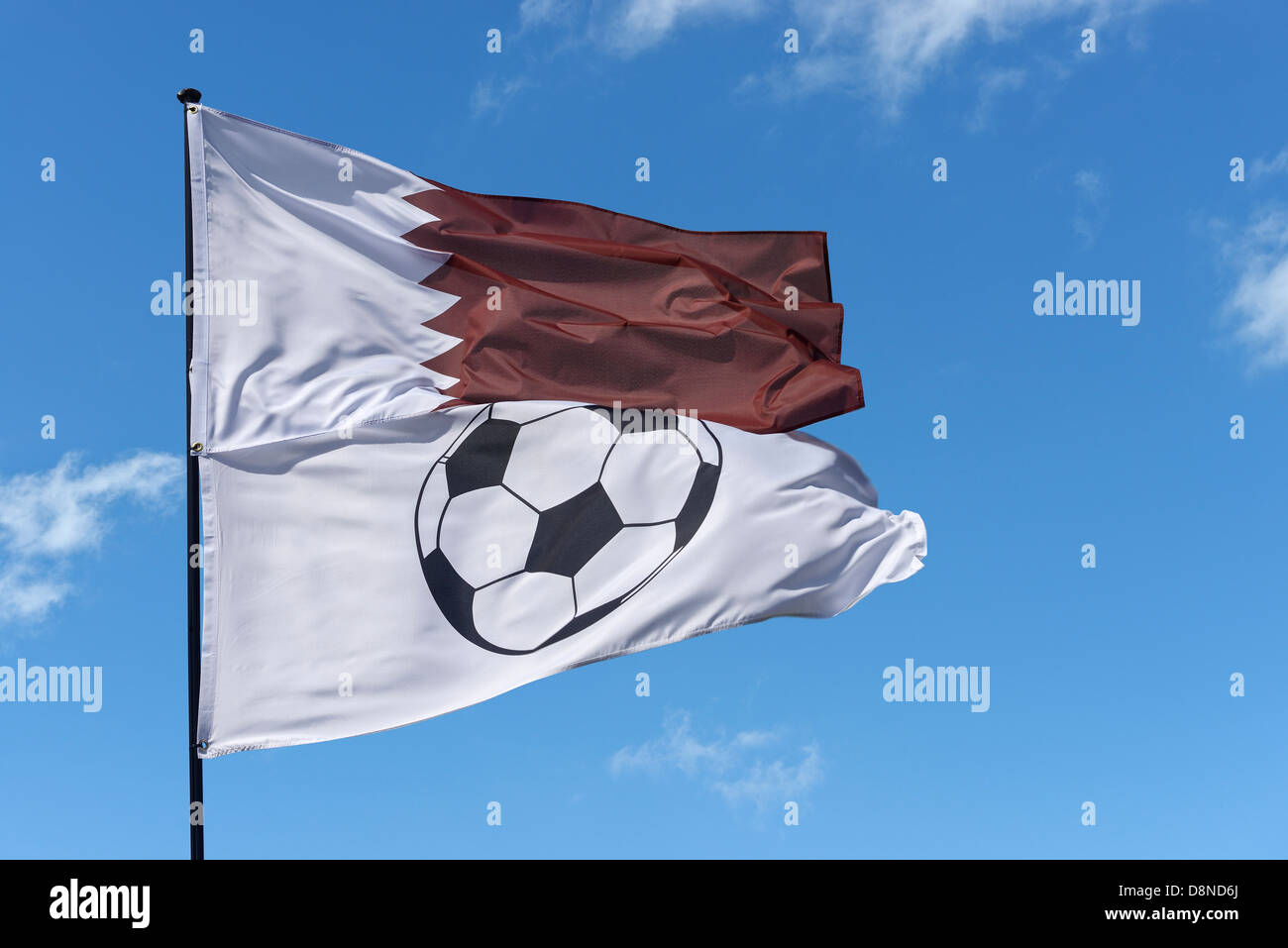 State of Qatar national flag and a football flag Stock Photo