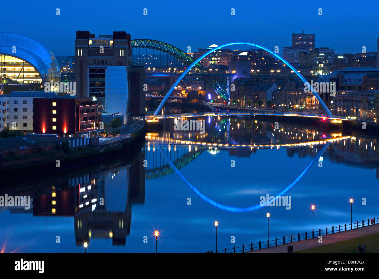 A dusk view of Newcastle and Gateshead quayside with reflections in the River Tyne looking towards the Tyne Bridge Stock Photo