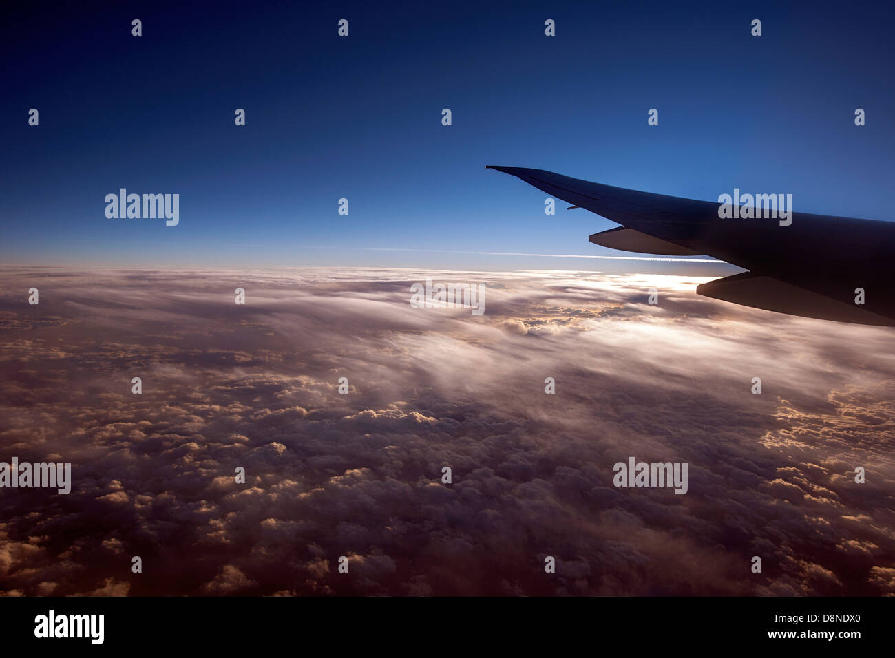 Flying airplane wing cloudy sunset hi-res stock photography and images ...