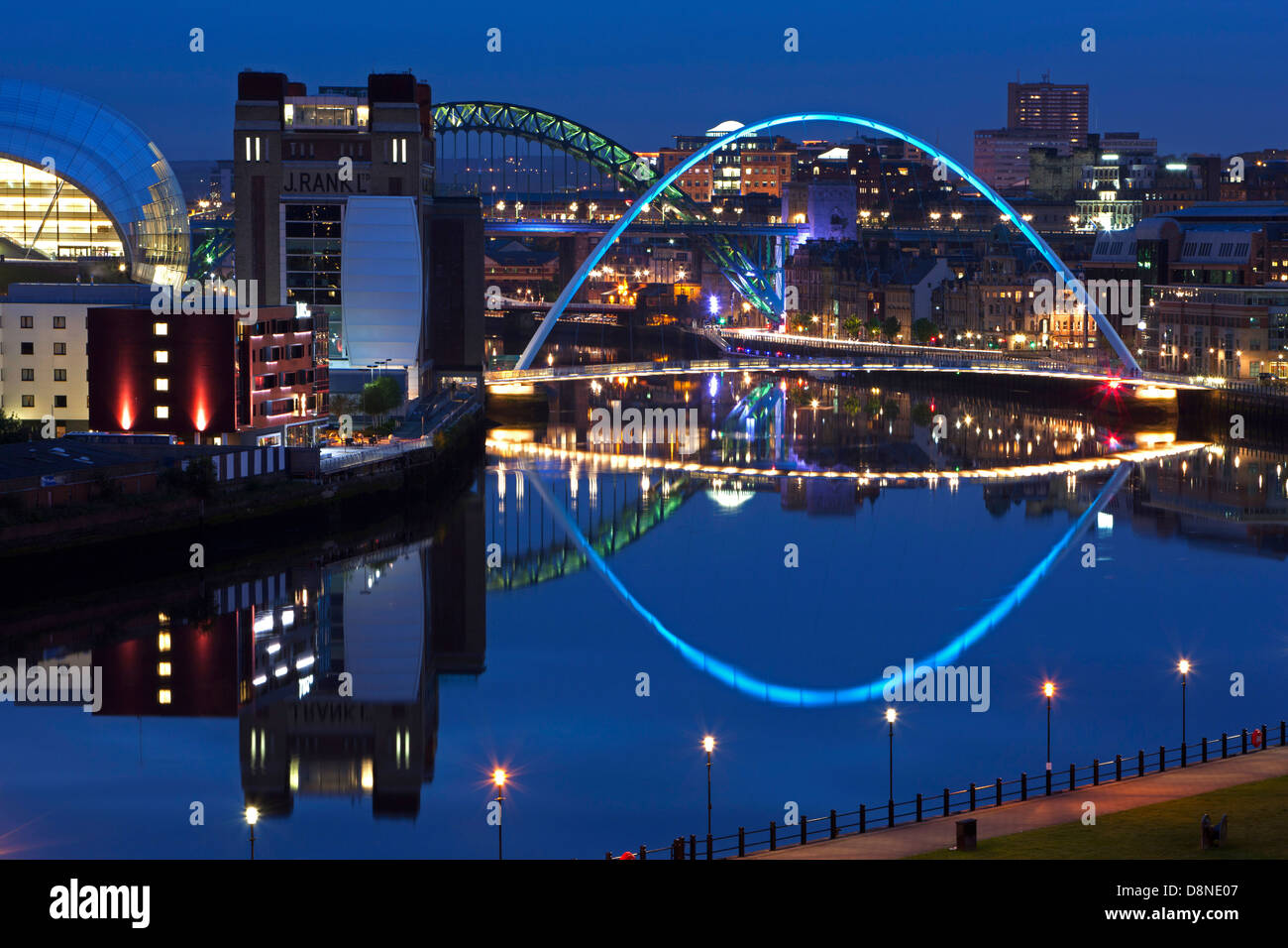 A dusk view of Newcastle and Gateshead quayside with reflections in the River Tyne looking towards the Tyne Bridge Stock Photo