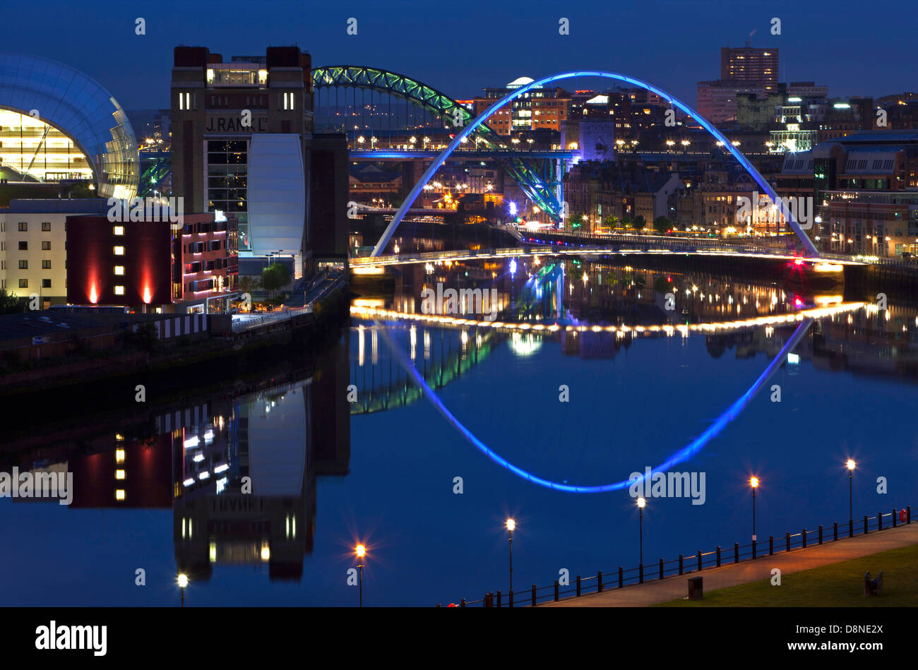 A view at dusk of Newcastle and Gateshead quayside with reflections in the River Tyne as viewed from down river Stock Photo