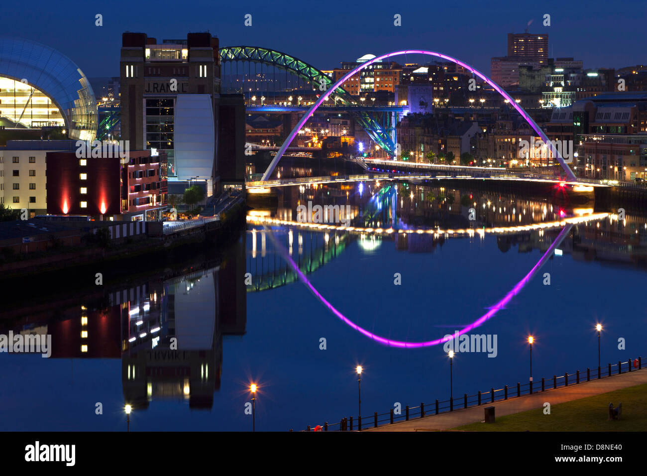 A view at dusk of Newcastle and Gateshead quayside with reflections in the River Tyne as viewed from down river Stock Photo