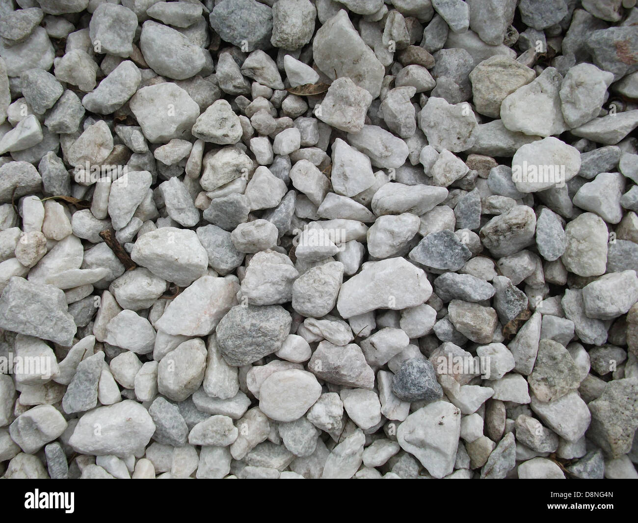 White and gray gravel of various shapes and sizes. Stock Photo