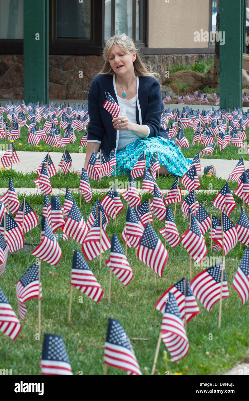 Distraught woman holding U.S. flag. Stock Photo