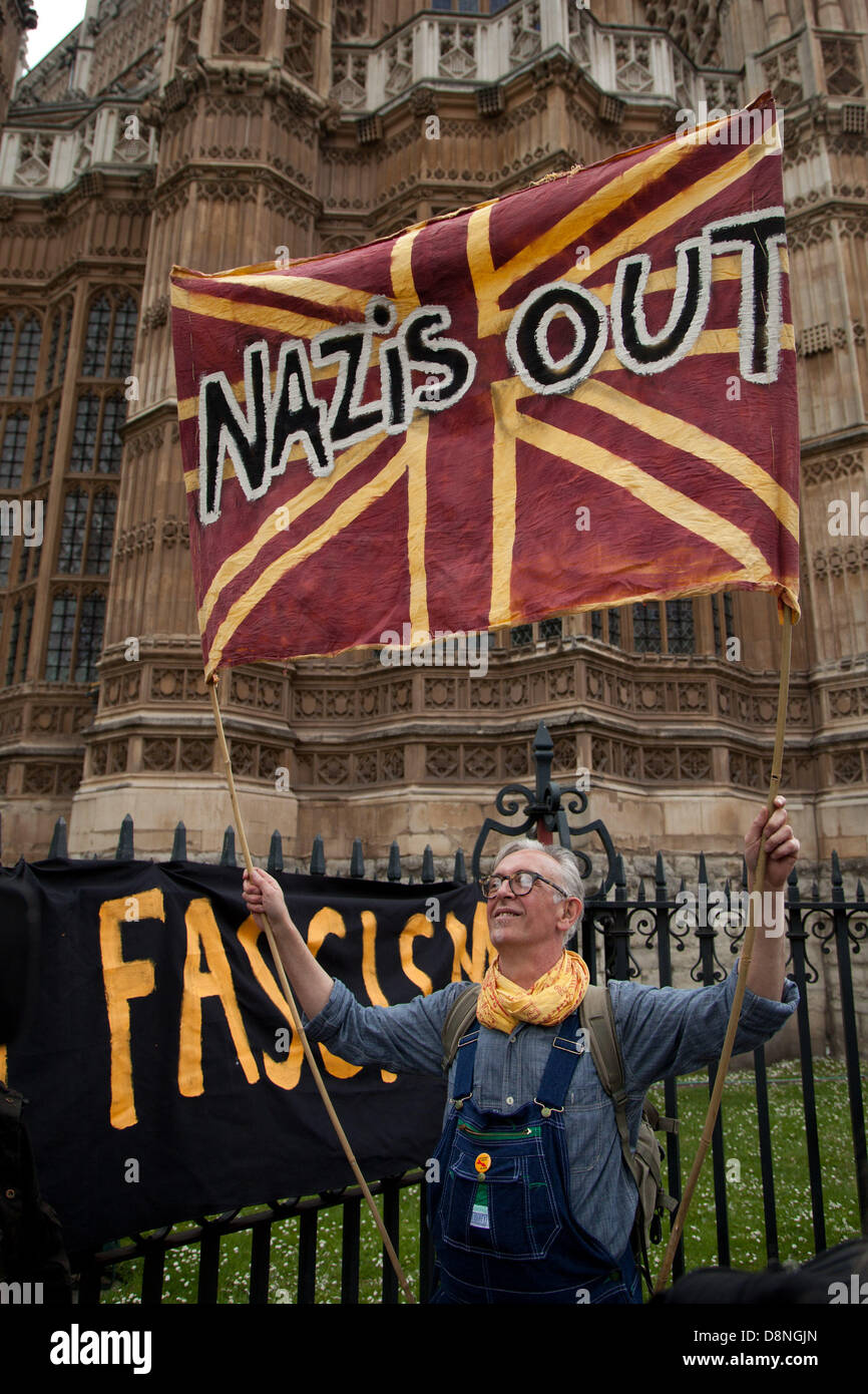 London, UK. 1st June 2013.  An anti fascist protestor holds up a banner saying 'Nazis Out' towards the direction wher BNP supporters were gathered. Credit:  nelson pereira/Alamy Live News Stock Photo