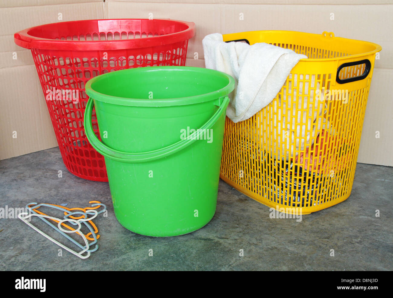Dirty laundry in the basket for washing using plastic pail. Concept of