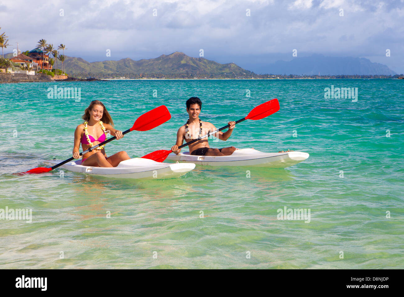 couple paddling surf skis in hawaii Stock Photo Alamy