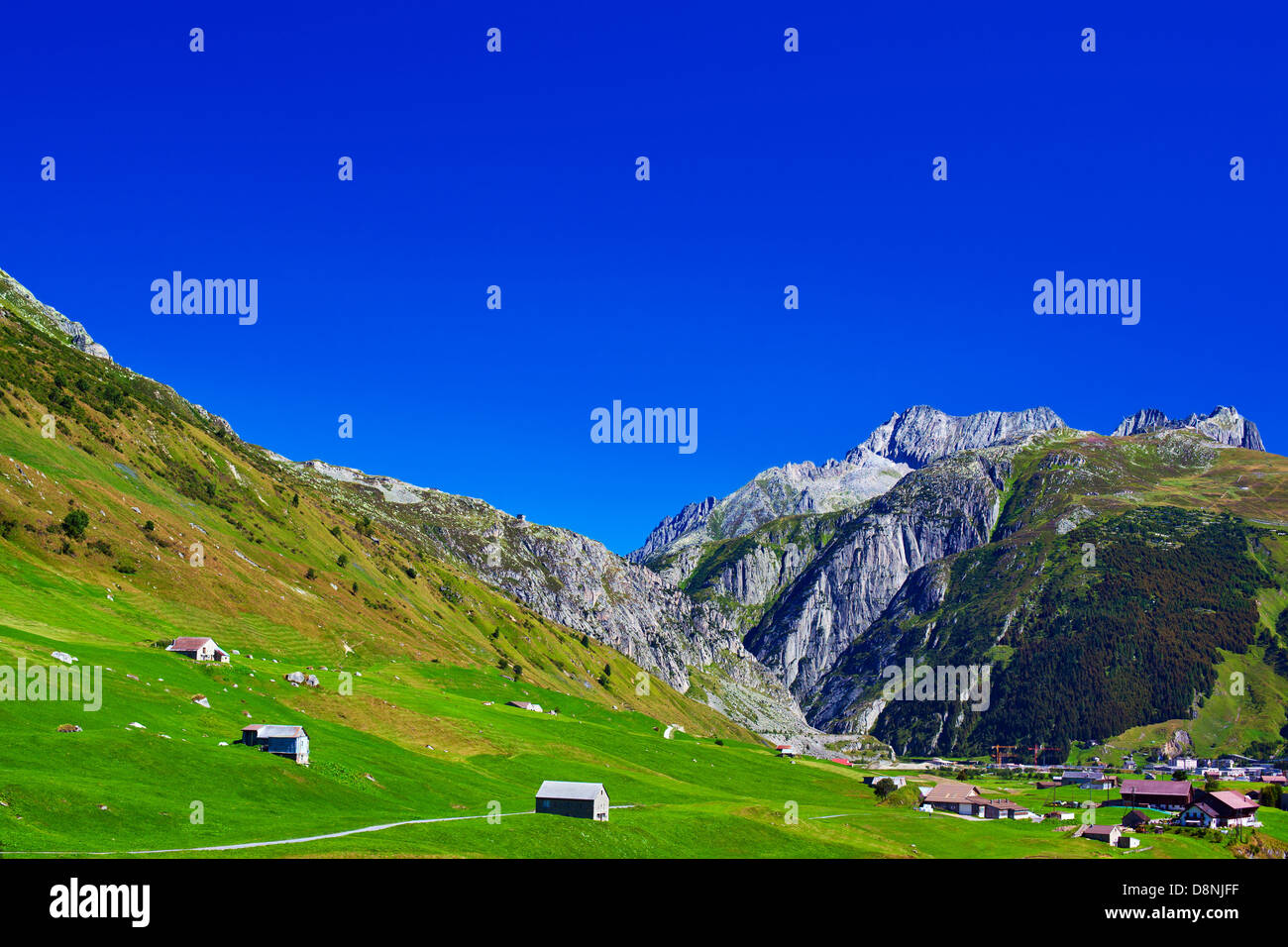 Alps mountains and town summer landscape Stock Photo - Alamy