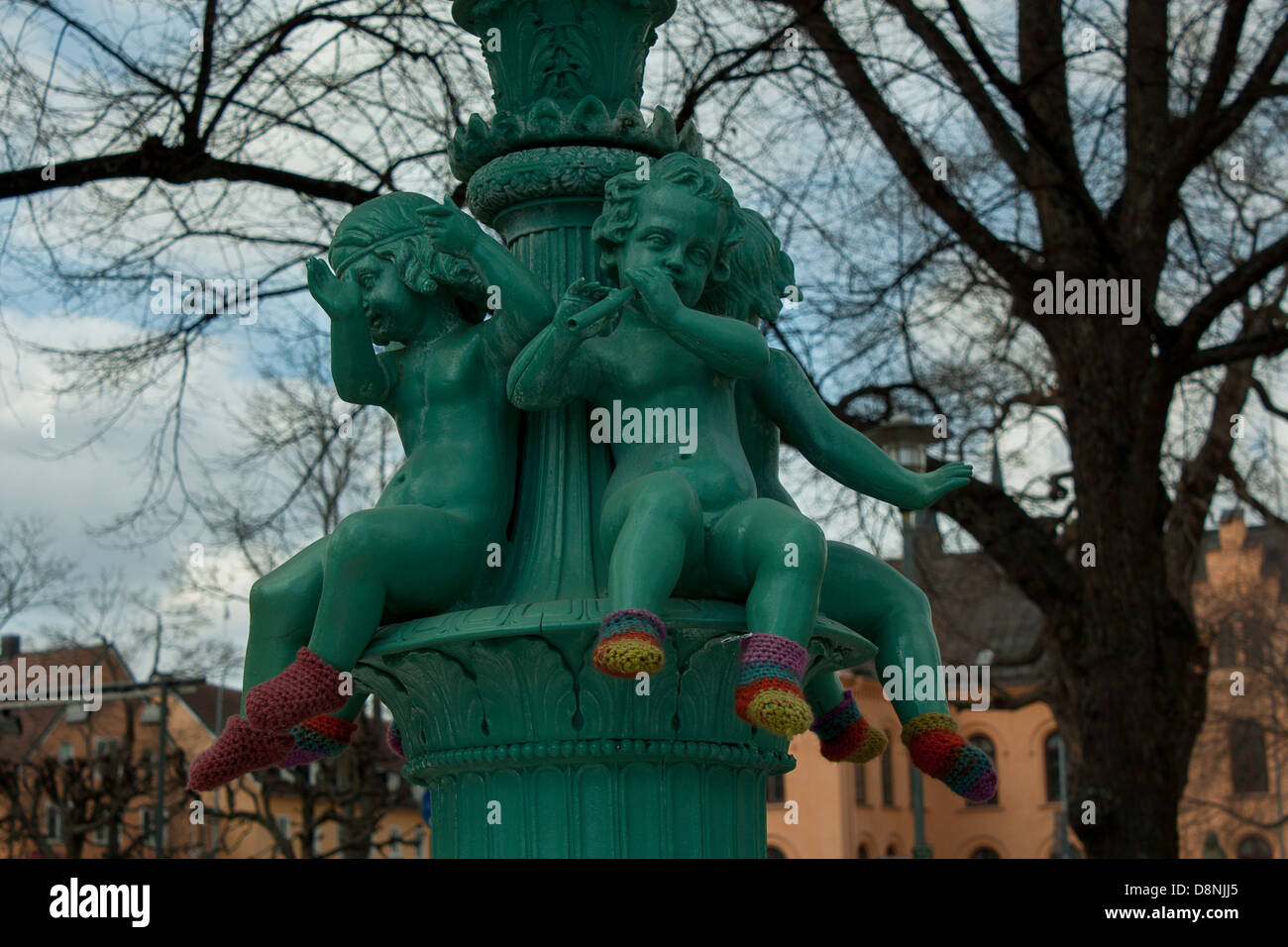 A statue in the city garden of Uppsala. Their feet's are warmed by socks knitted by a anonymous source. Stock Photo