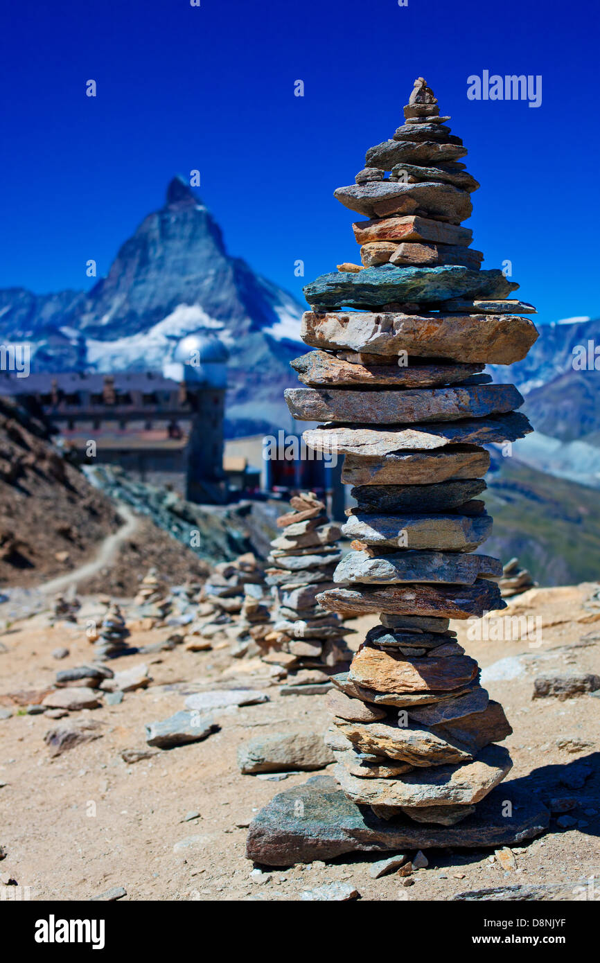 Big hand-made stone tower in Alps. Stock Photo