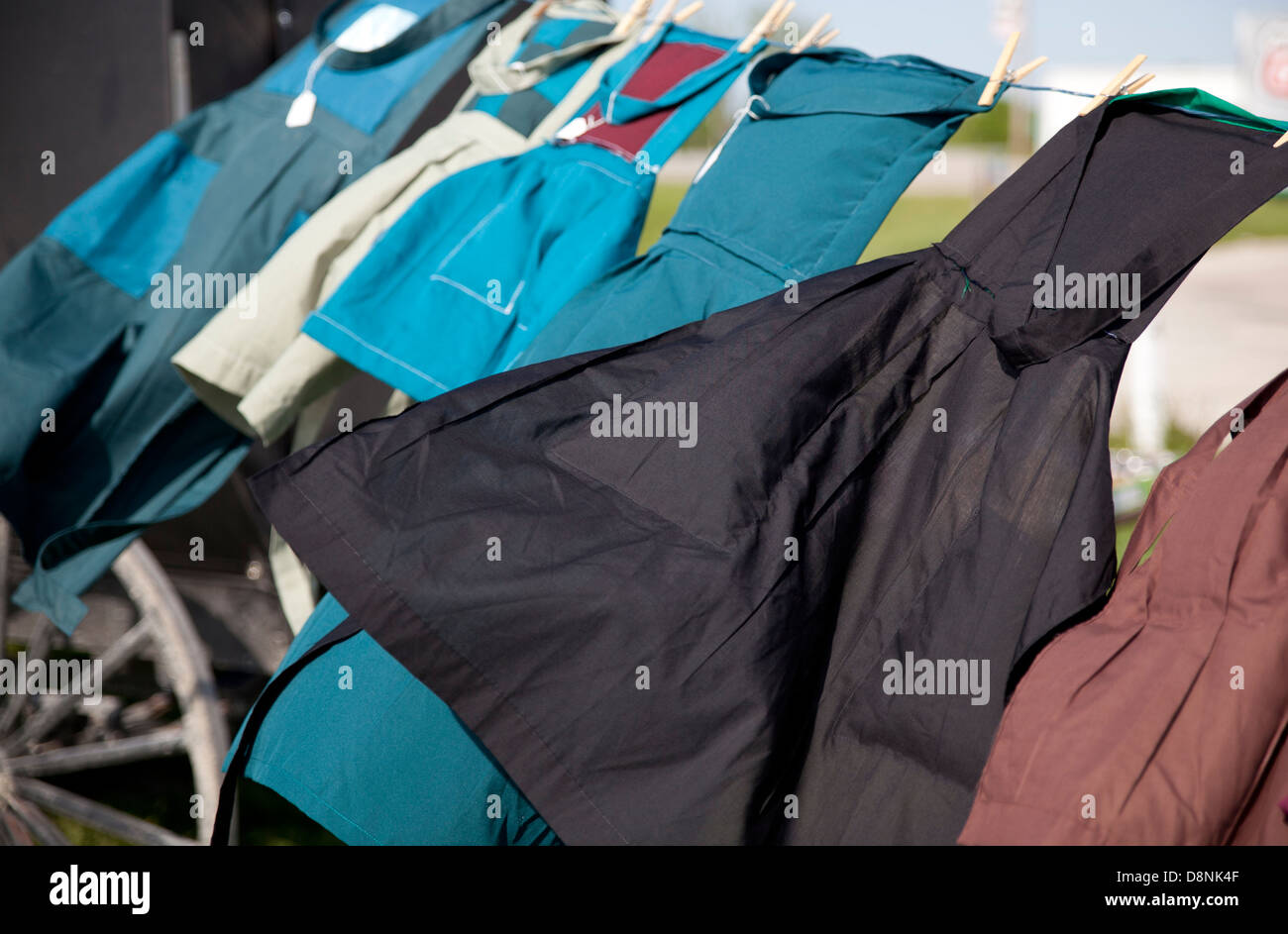 Hand-made aprons crafted by the Amish hang on a clothesline. Stock Photo