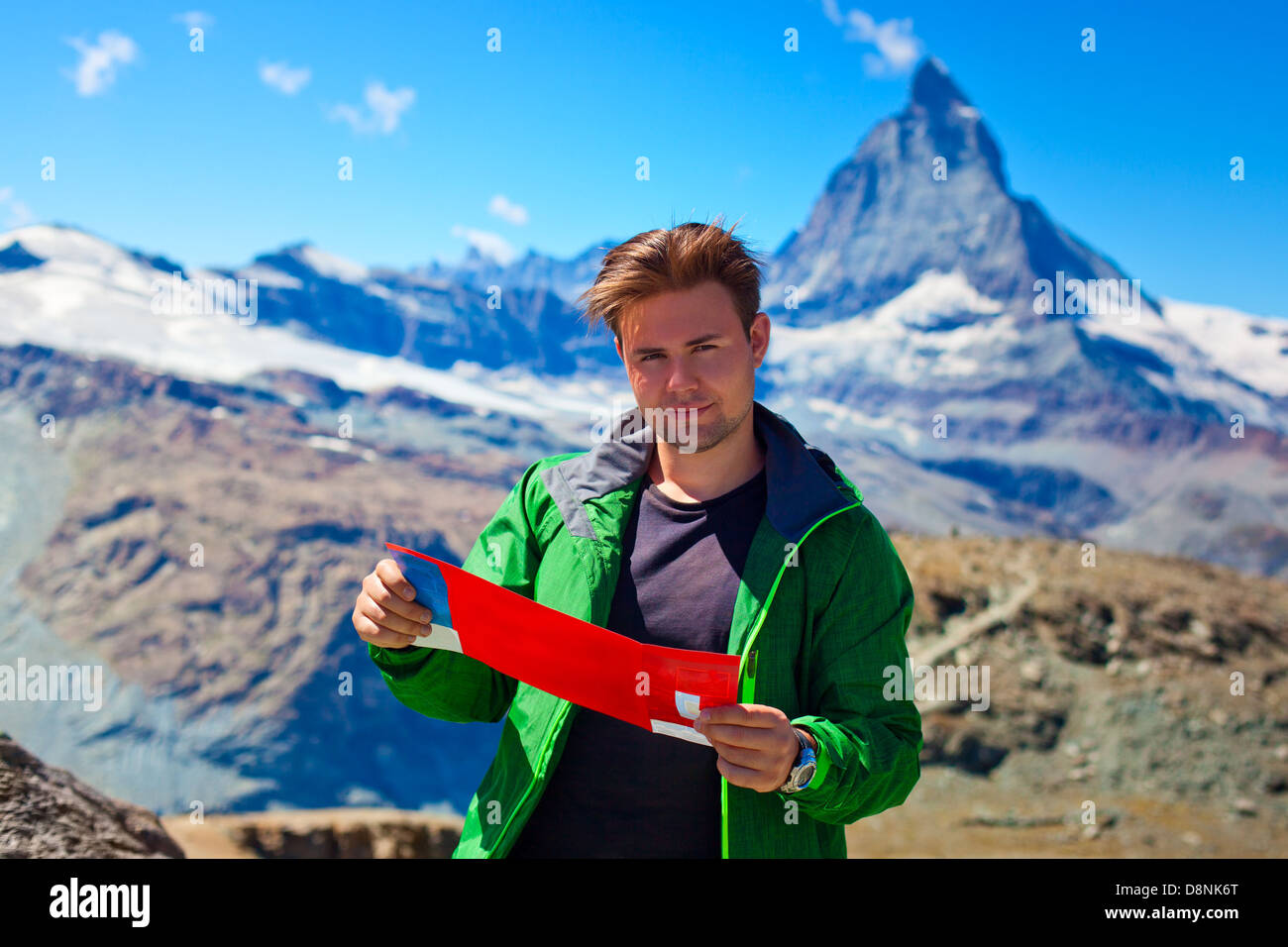 Tourist with map on mountains background. Stock Photo