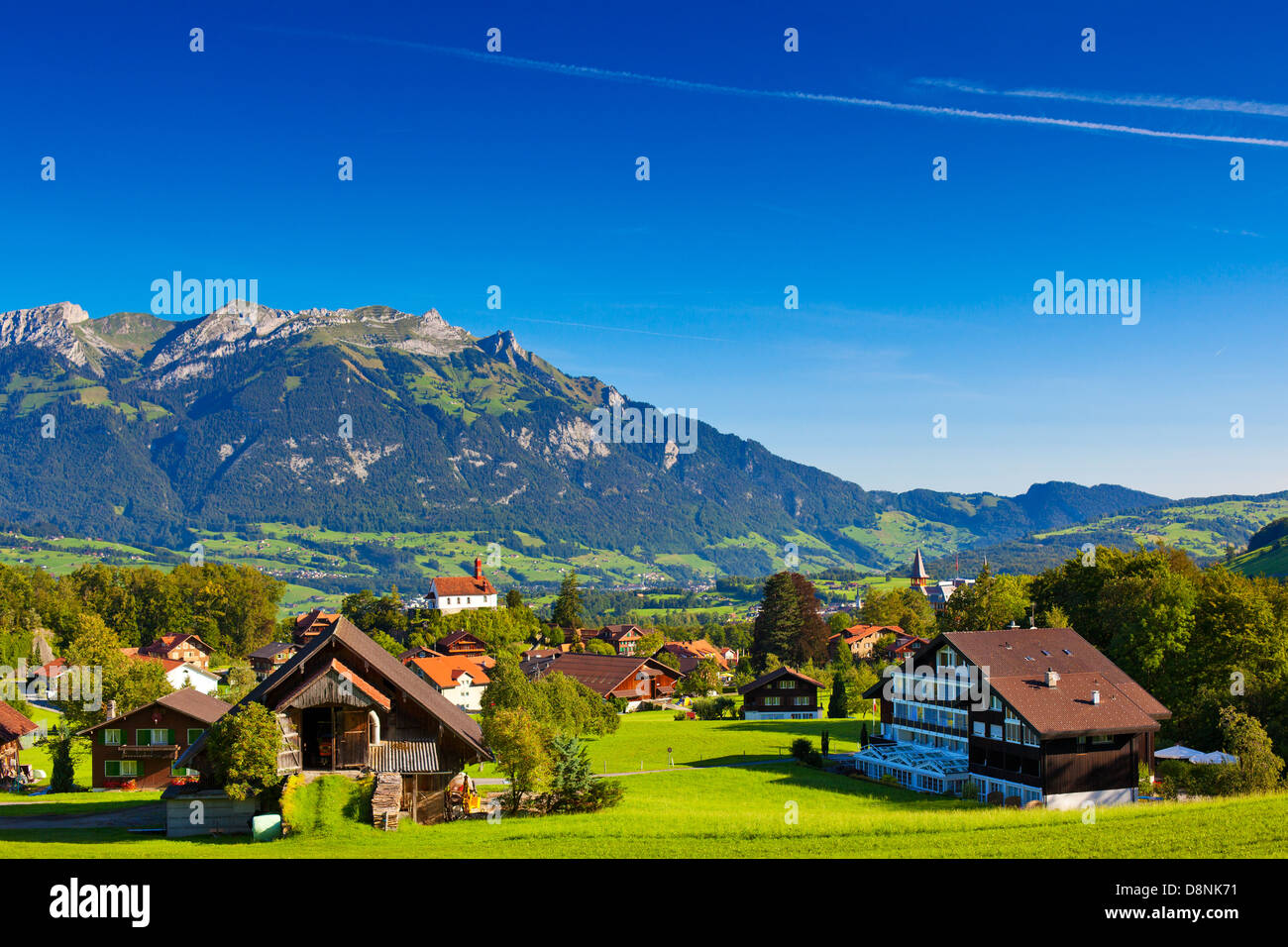 Alps mountains and town summer landscape Stock Photo - Alamy