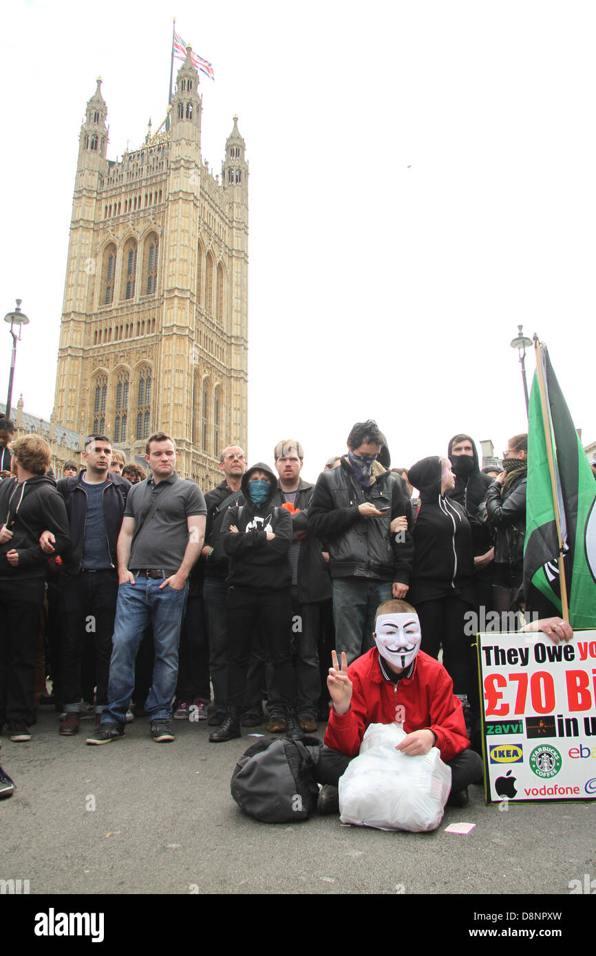 London, UK. 1st June, 2013. A protestor wearing a anonymous mask seen during the United Against Fascism sit-in along the road leading to Whitehall. Credit David Mbiyu/Alamy Live News Stock Photo