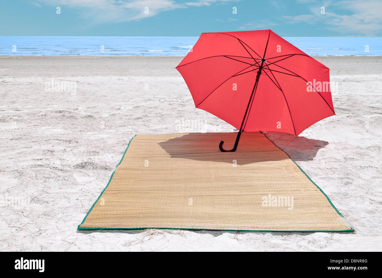 Red umbrella and bamboo mat on the beach Stock Photo - Alamy
