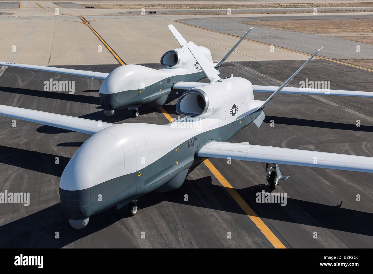 Northrop Grumman MQ-4C Triton unmanned aerial vehicles on the tarmac at a Northrop Grumman test facility April 21, 2013 in Palmdale, CA. The Triton is undergoing flight testing as an unmanned maritime surveillance vehicle. Stock Photo