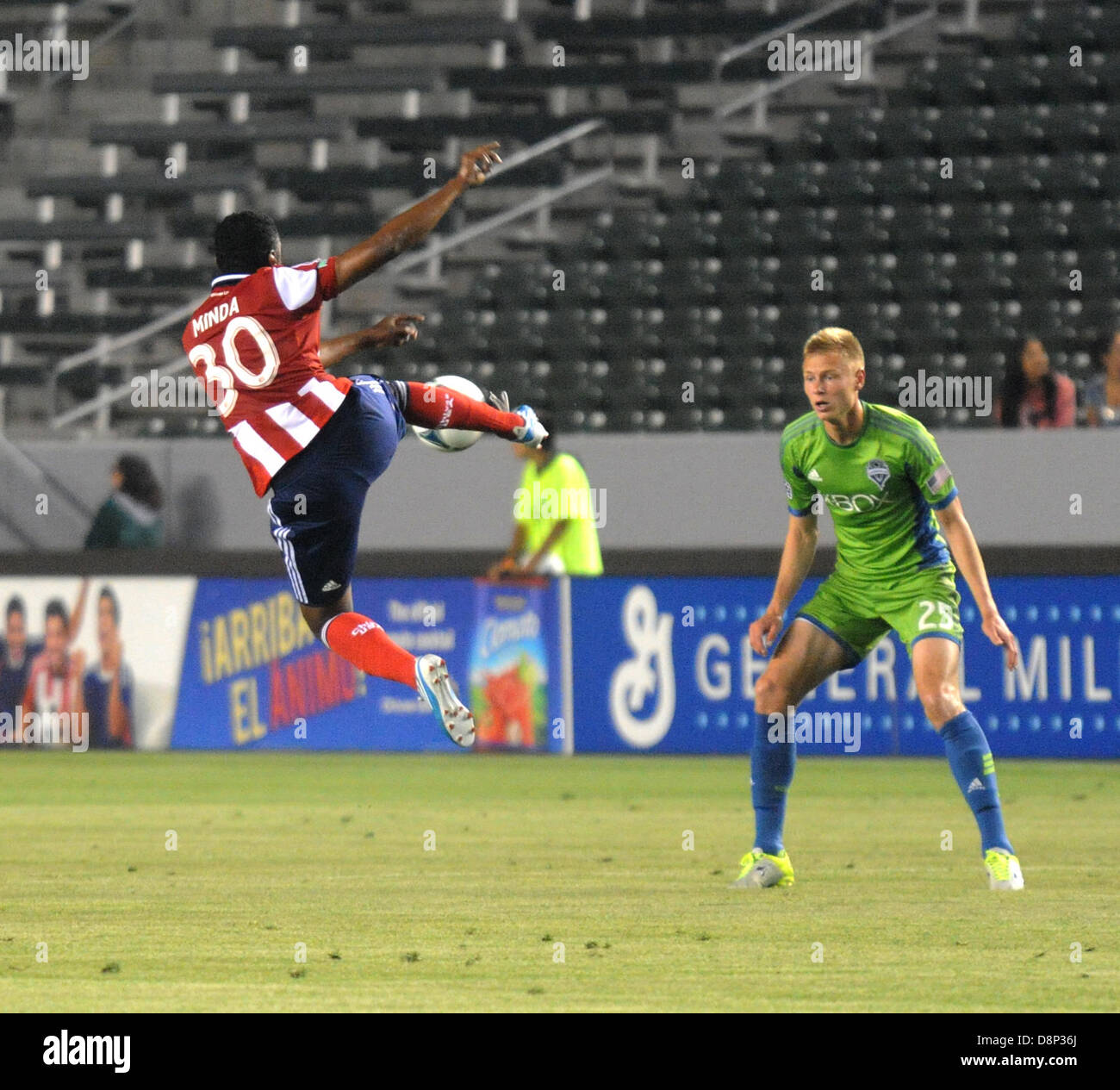 Carson, California, USA. 1st June, 2013. MLS-Major League Soccer- Chivas USA mid fielder OSWALDO MINDA receiving a pass in mid air as Seattle Sounders defender ANDY ROSE watches during the first half of play at The Home Depot Center, Carson, California, USA, June 1, 2013..Seattle went on to win the match 2 to 0...Credit Image  cr  Scott Mitchell/ZUMA Press (Credit Image: Credit:  Scott Mitchell/ZUMAPRESS.com/Alamy Live News) Stock Photo