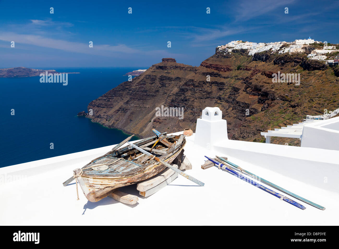 Boat on a roof at Firostefani near Fira Santorini Greece. In the background is Skaros Rock at Imerovigli. Stock Photo