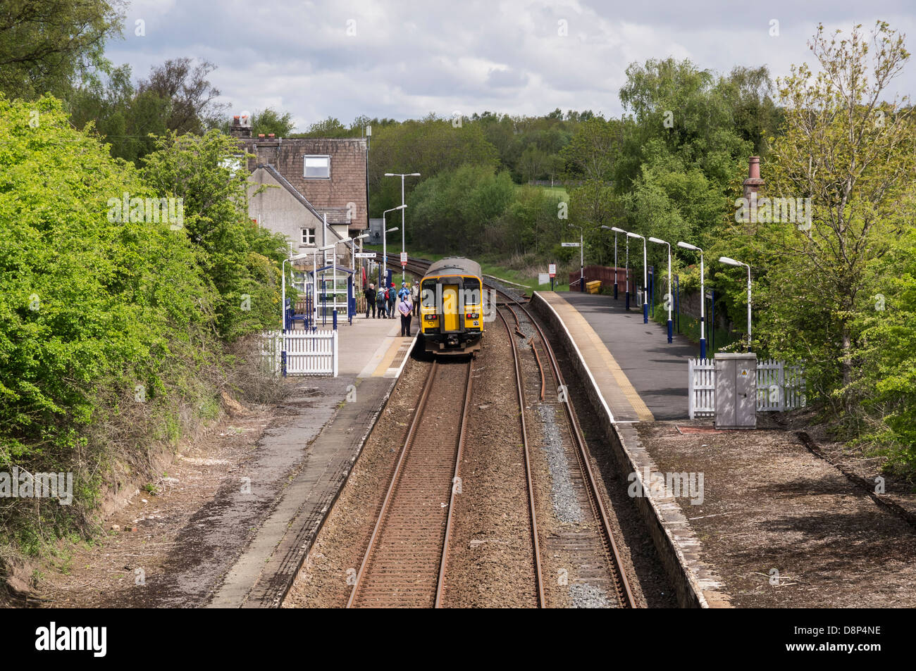 Passengers boarding a train at Silverdale Station, Lancashire. Stock Photo