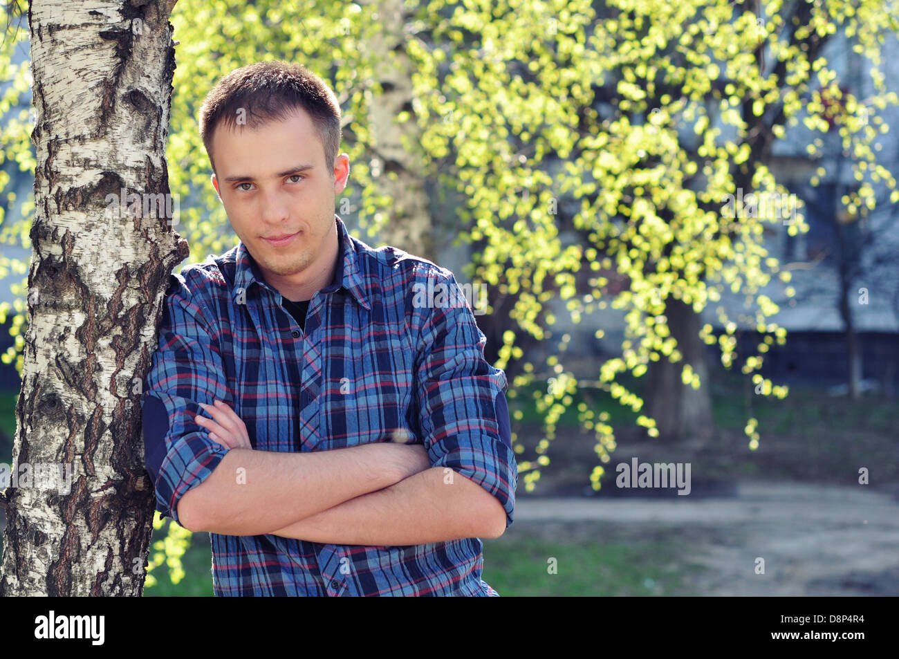 Outdoor portrait of young handsome man in summer park Stock Photo