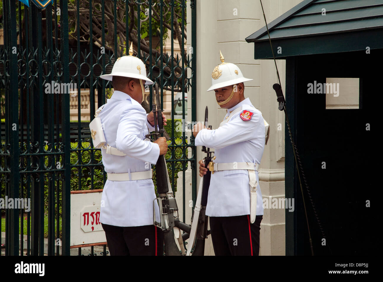 Guards change at the gate of the Borom Phiman mansion on the grounds of the Grand Palace, Bangkok, Thailand. Stock Photo