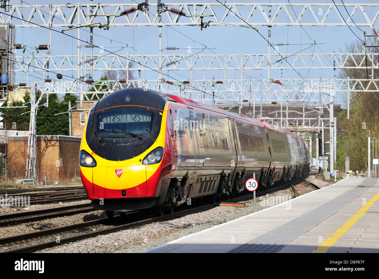 Virgin Pendolino express passenger train passing through Stafford