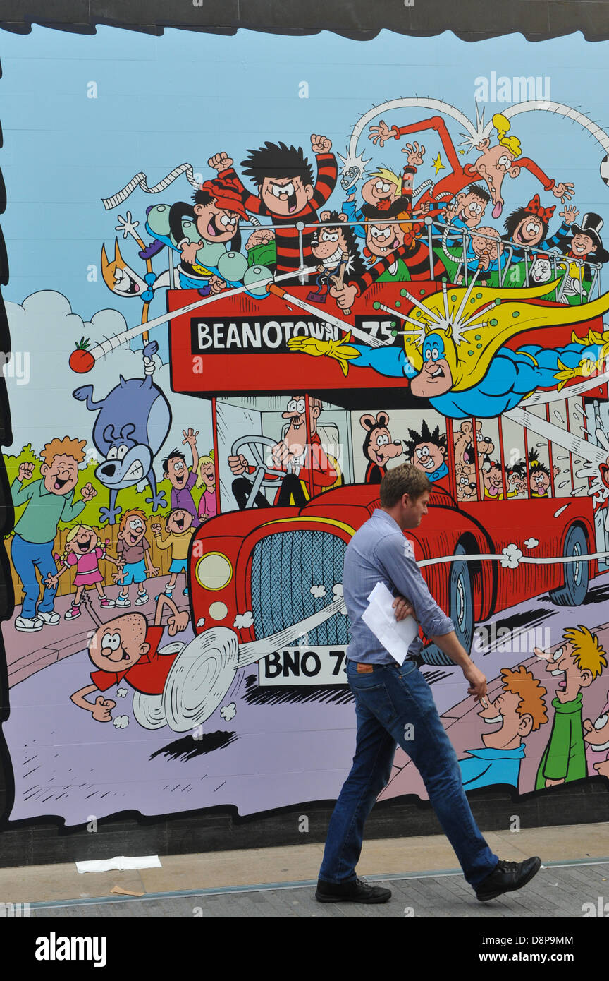 Southbank Centre, London, UK. 2nd June 2013. A man walks past a poster for Beanotown, a celebration of the children's comic. Beanotown in the Southbank Centre in London, 'Beanotown is the home of Dennis the Menace and Gnasher, The Bash Street Kids, Minnie the Minx, Roger the Dodger, plus all the other comic strip superstars from The Beano'. Beanotown is on from 31st May to 8th September. Credit:  Matthew Chattle/Alamy Live News Stock Photo