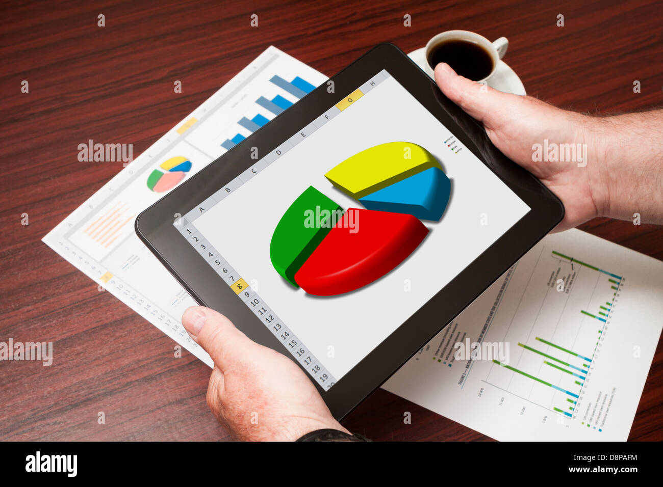 Modern workplace with digital tablet showing charts and diagram on screen Stock Photo