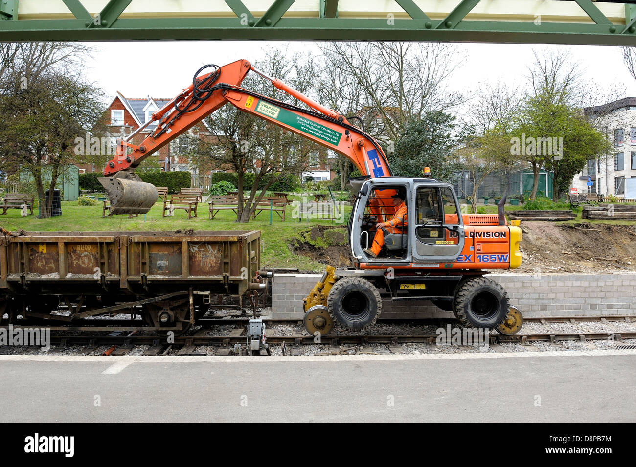 Fiat-Hitachi EX-165W Mega10 Railer Excavator being used to clear the embankment at Swanage railway station Dorset England uk Stock Photo