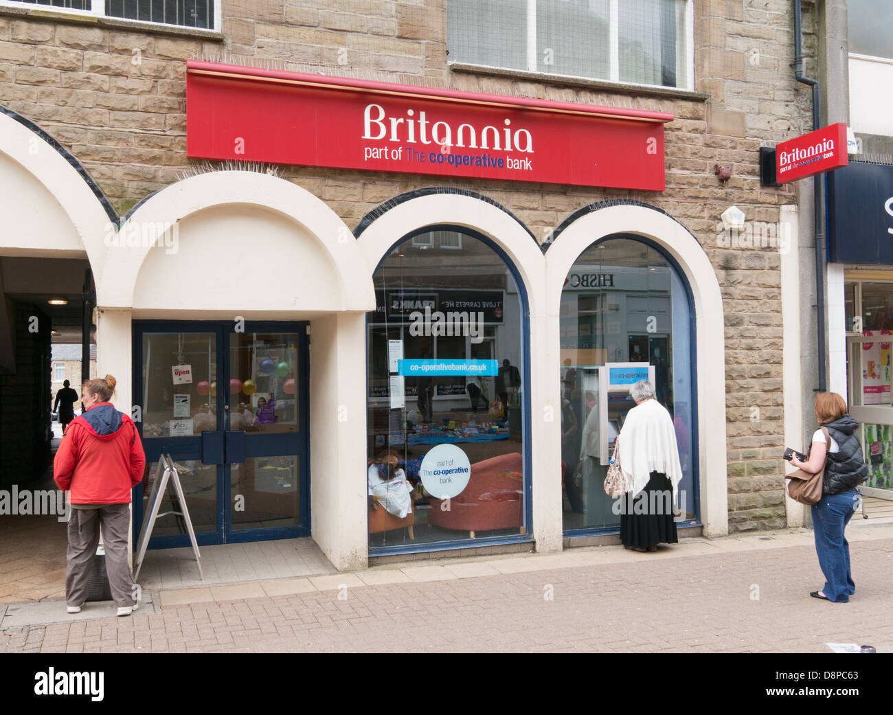 People waiting to use ATM Britannia Building Society ( Co-op bank) in Consett, north east England, UK Stock Photo