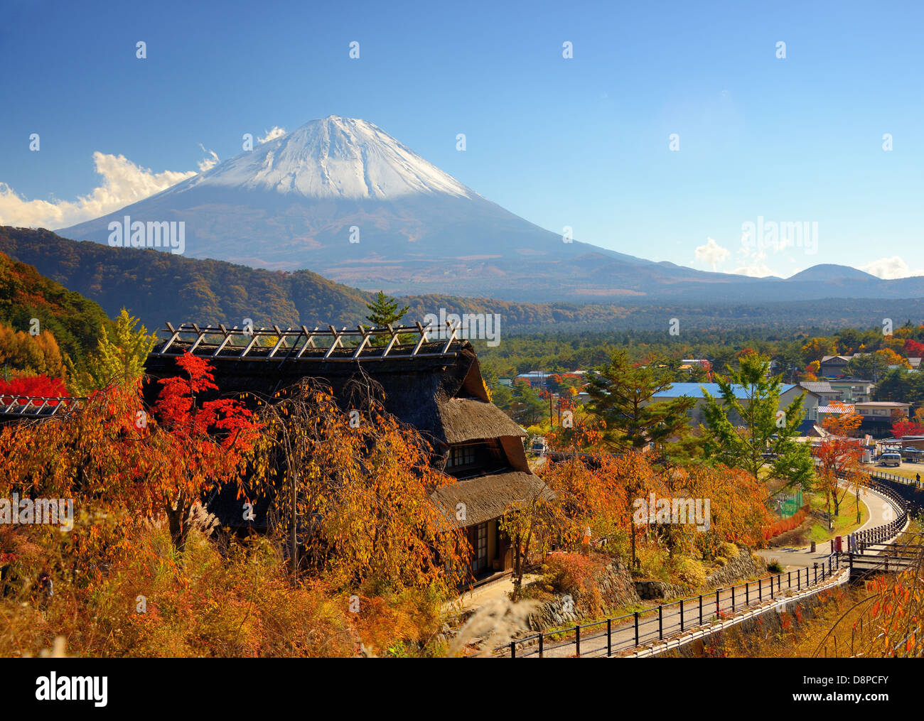 Historic Japanese huts in Kawaguchi, Japan with Mt Fuji Visible in the distance. Stock Photo