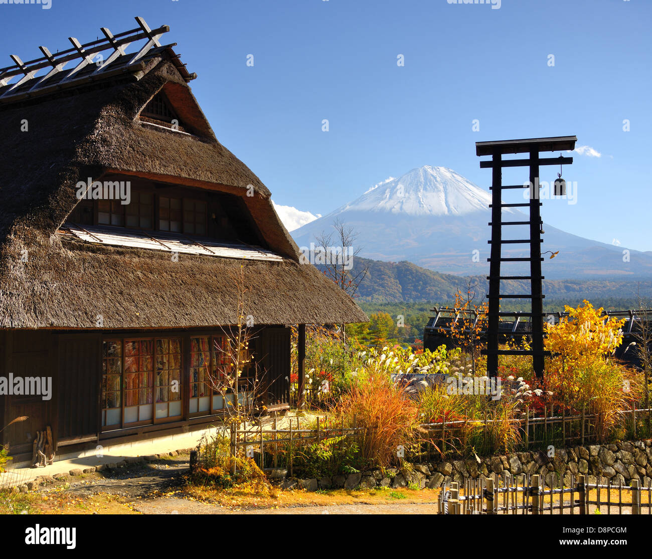 Historic Japanese huts in Kawaguchi, Japan with Mt Fuji Visible in the distance. Stock Photo