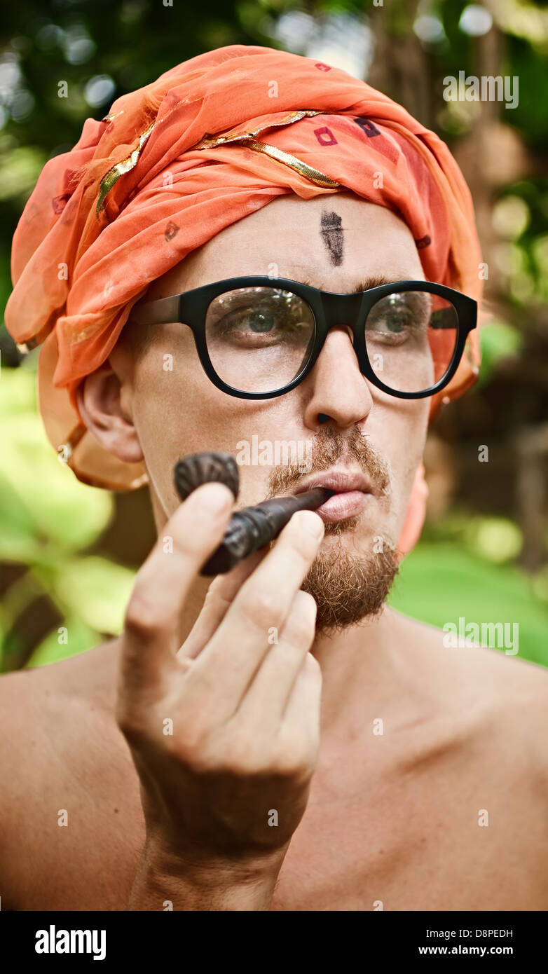 Portrait of a man smoking pipe in glasses Stock Photo