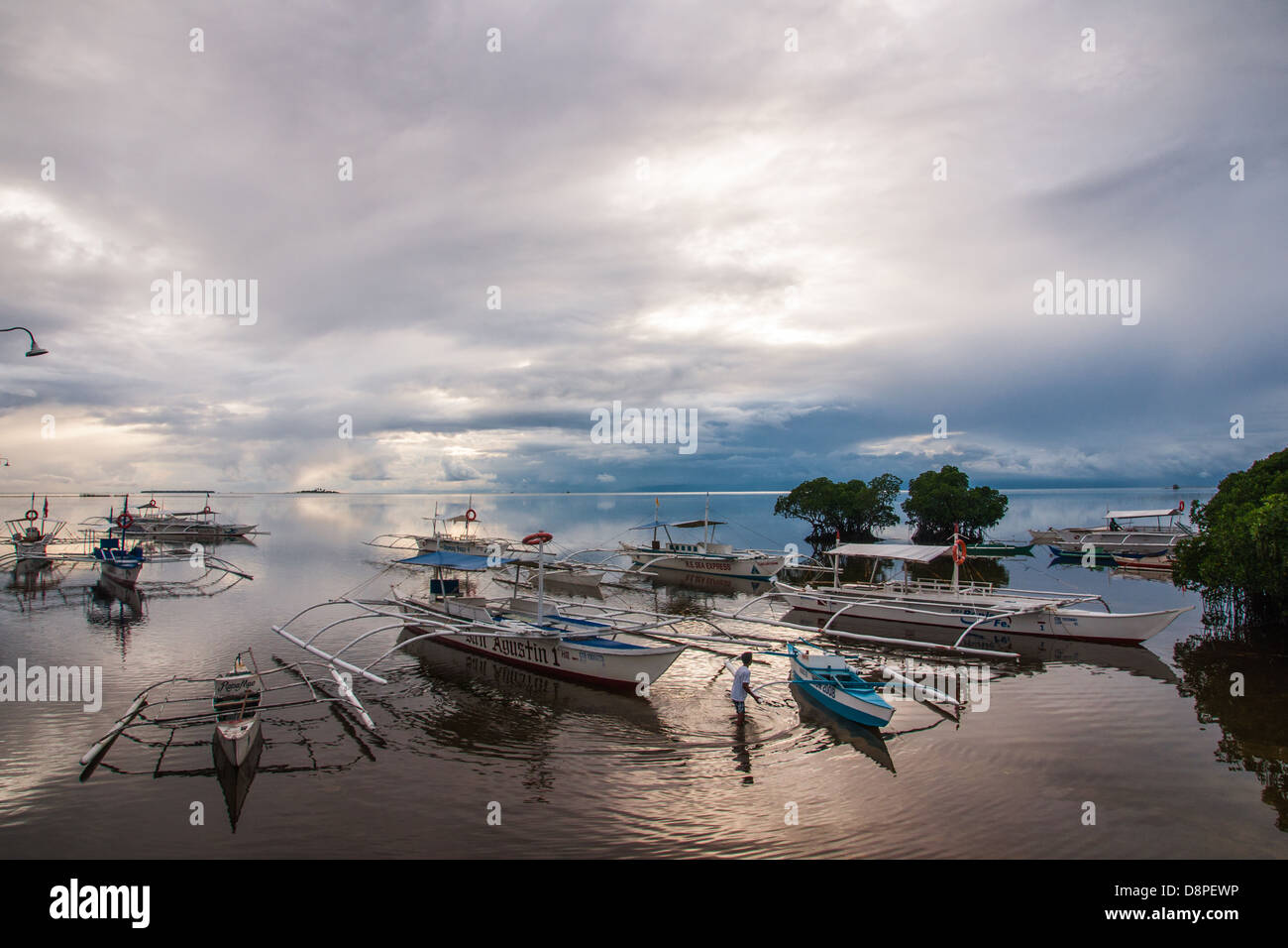 Harbour full of outrigger bangkas - traditional Filipino fishing boats Stock Photo