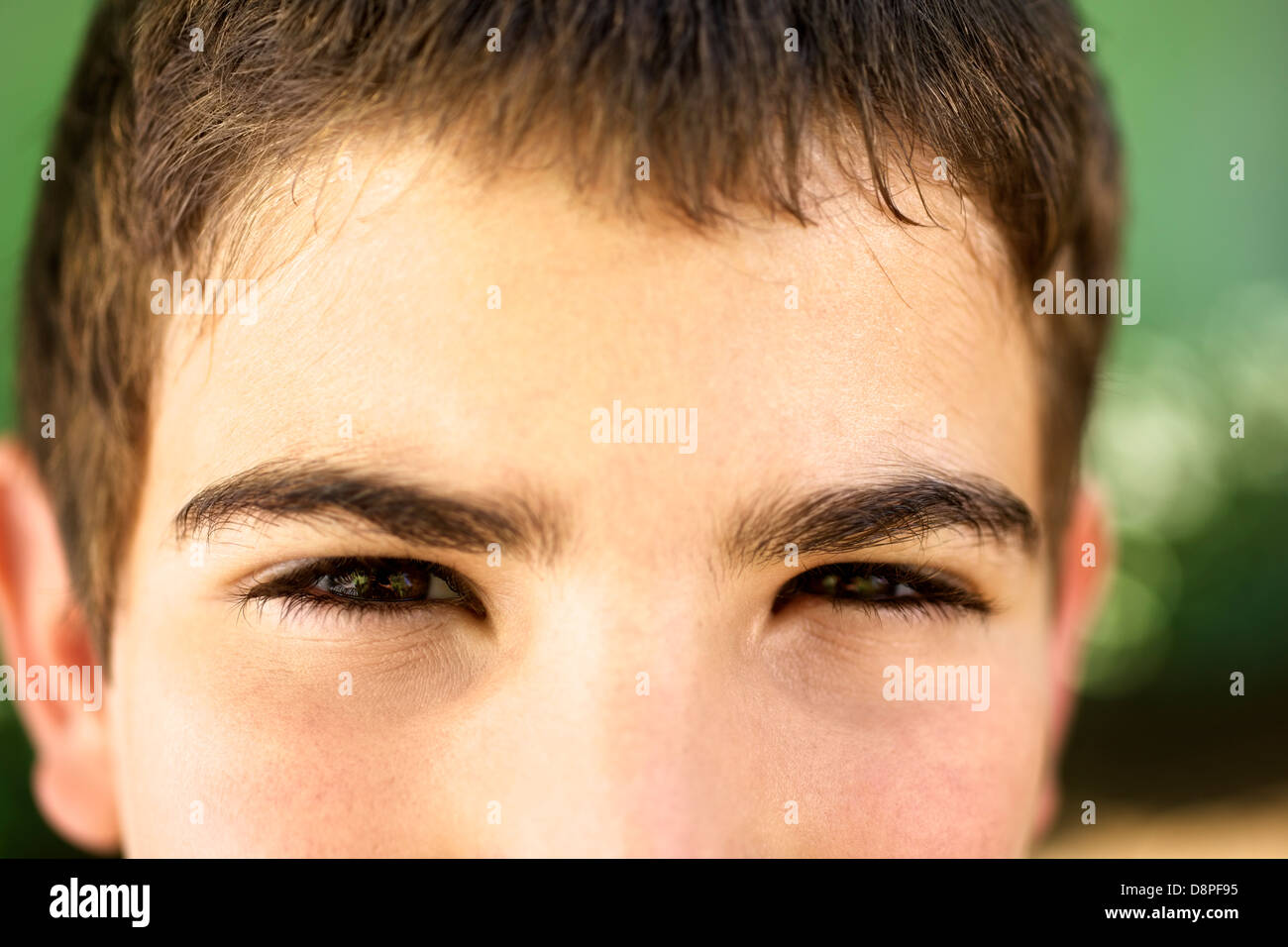 Young people and emotions, portrait of serious kid looking at camera. Closeup of eyes Stock Photo