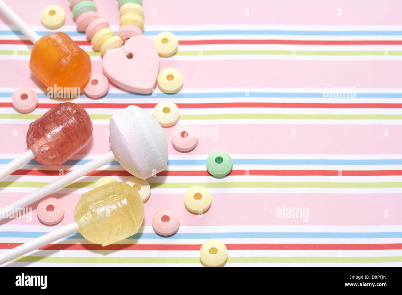 Lollies and sweets on striped background  1 Stock Photo