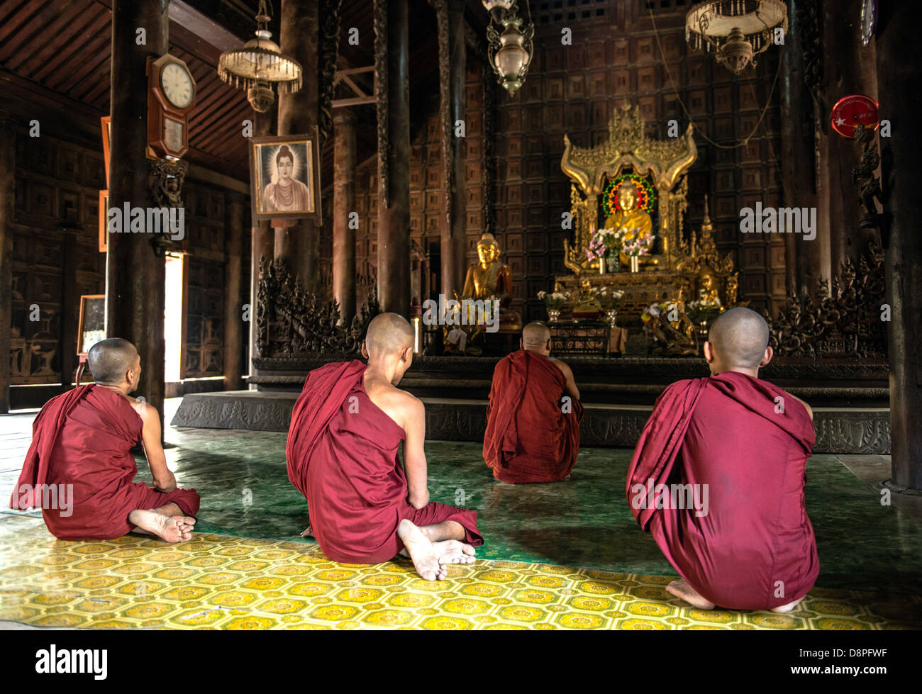 Buddhist monks preying at monastery near Mandalay Burma Myanmar Stock Photo