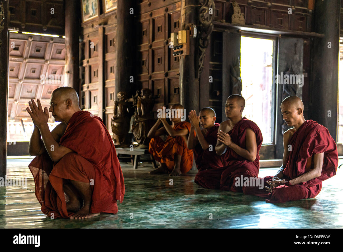 Buddhist monk preying at monastery near Mandalay Burma Myanmar Stock Photo