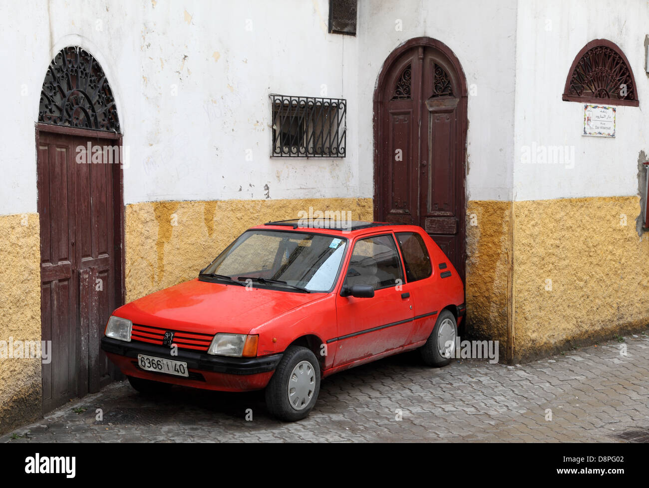 Old Peugeot 205 parked in a narrow street in Tanger, Morocco Stock Photo