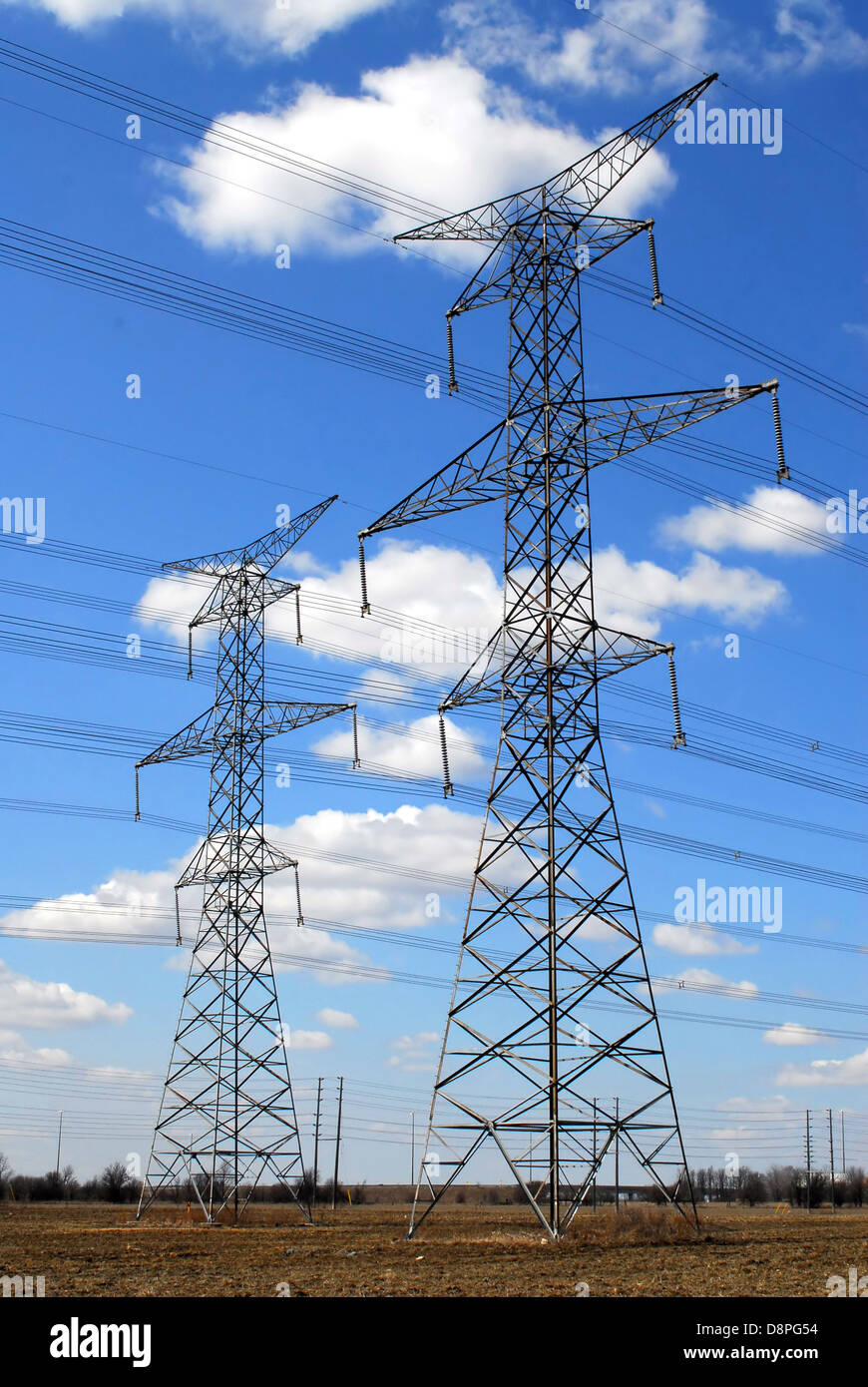 Electrical transmission tower and power lines on cloudy sky Stock Photo ...