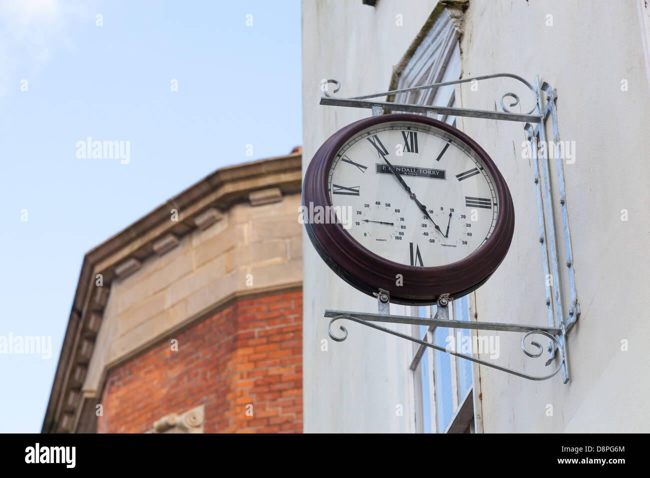 Ornate outside wall clock with humidity and temperature gauges Stock Photo Alamy
