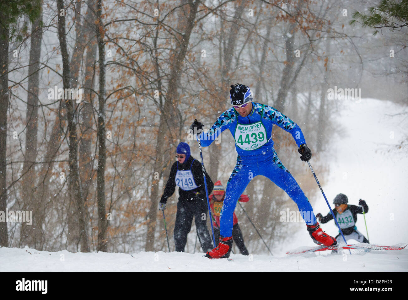 Cross country skiing competitors climb a hill during the Mora Vasaloppet. Stock Photo