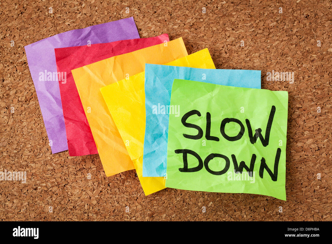 slow down - lifestyle concept or advice - handwriting on colorful sticky notes Stock Photo